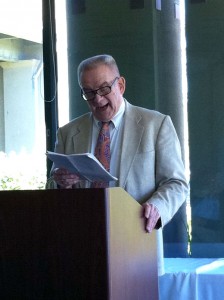 man at podium reading a speech